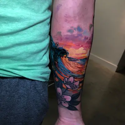 Vibrant tattoo featuring waves and flowers on a forearm.