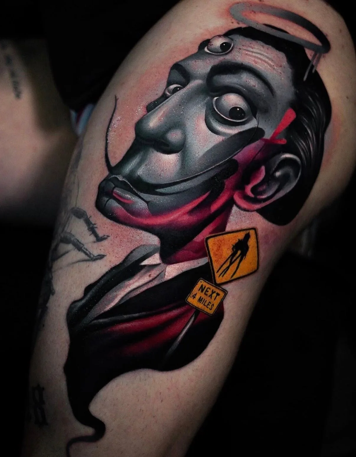 Stylized realistic portrait of Salvador Dali on a thigh.