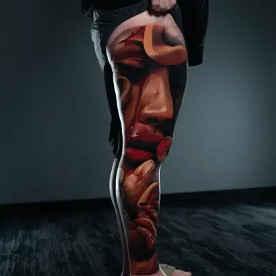 Realistic leg tattoo with abstract face and hands