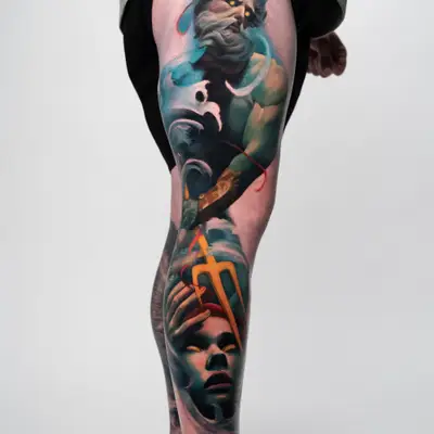 Colorful mythological tattoo on leg depicting a god and trident.