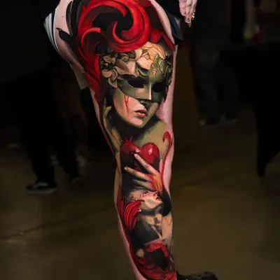 A vibrant, detailed tattoo on a person's thigh featuring a masked figure and red decorative elements.