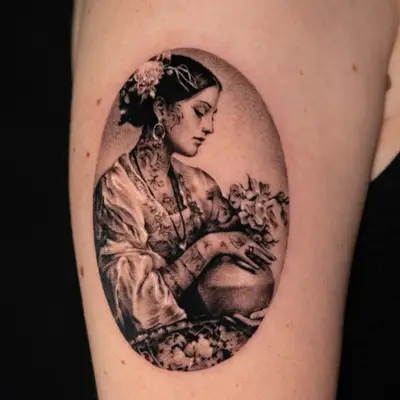Micorealism tattoo of a woman with tattoos and flowers in her hair.
