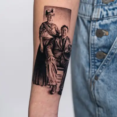 Portrait tattoo of Frida Khalo and Diego Rivera set on an inner forearm.