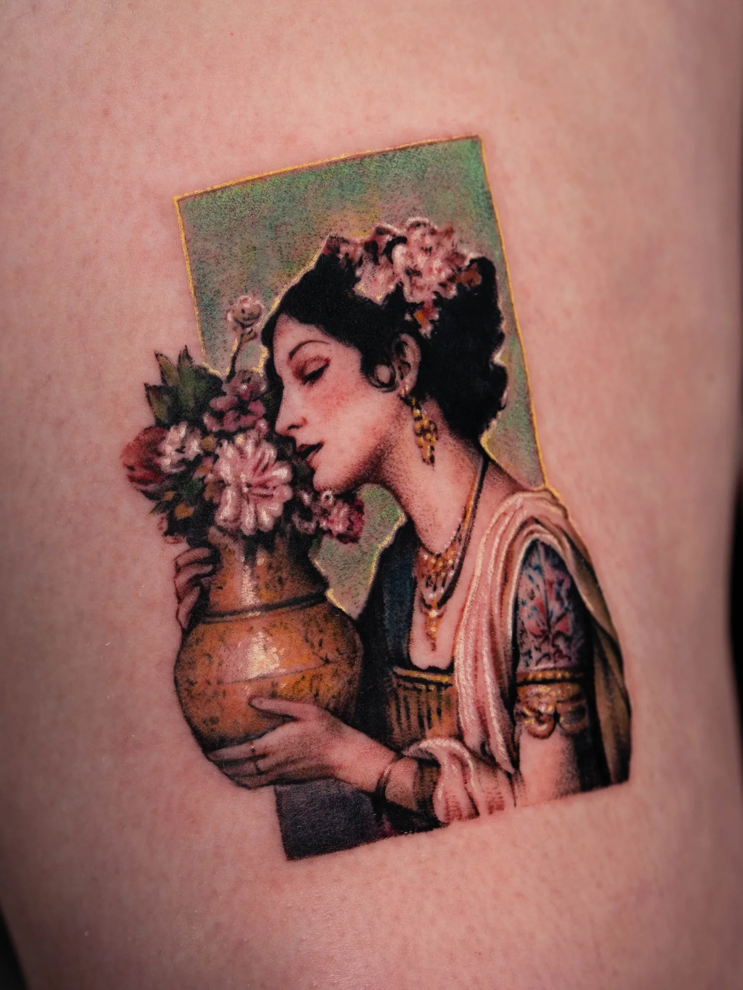 A woman with flowers and a vase in a realistic tattoo style.