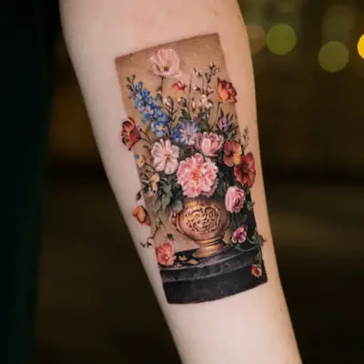 Microrealism tattoo of a still life of flowers on the inner forearm.