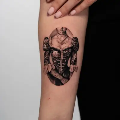 Micorealism tattoo of a victorian woman in black and grey set in an oval frame on the forearm.