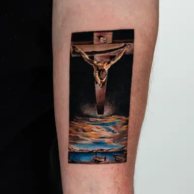 Painting tattoo of Salvador Dali's Christ of Saint John of the Cross on the forearm.