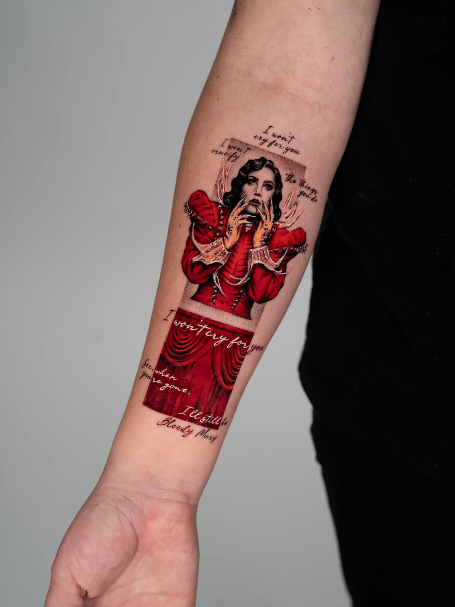 Portrait of Lady Gaga in a red dress on a forearm.