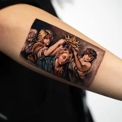 Color painterly tattoo of two angels lowering a gold crown onto the head of the Virgin, after a Baroque painting, on a forearm.