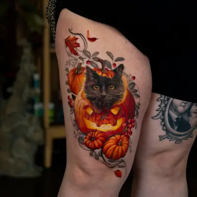 Tattoo of a black cat in a pumpkin with autumn leaves and berries.