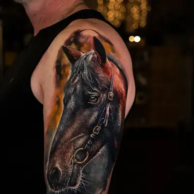 Realistic tattoo of a horse's head on upper arm