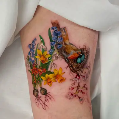 Realistic tattoo of a bird on a nest with flowers and eggs.