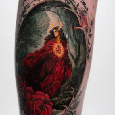 Dark fantasy romance tattoo of a woman in a dark forest in color on a thigh.