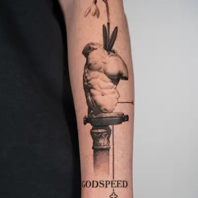 Tattoo of a muscular torso with a flower, text reads 'GODSPEED' and has a key design.