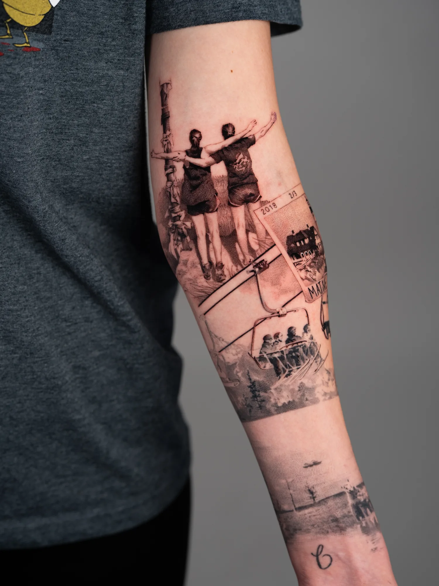 Tattoo sleeve of travel photographs in a black and grey realism style.