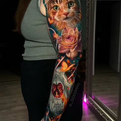 Realistic sleeve tattoo of a cat, rose, and skull