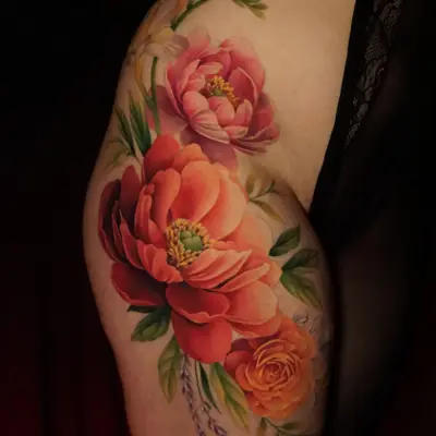 A vibrant tattoo featuring colorful peonies and flowers on the hip.