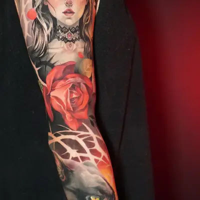 Tattoo featuring a gothic woman with long hair, roses, and a panther on a full sleeve.