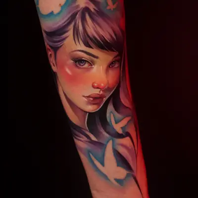 Portrait of a woman with butterflies in vibrant colors on forearm.