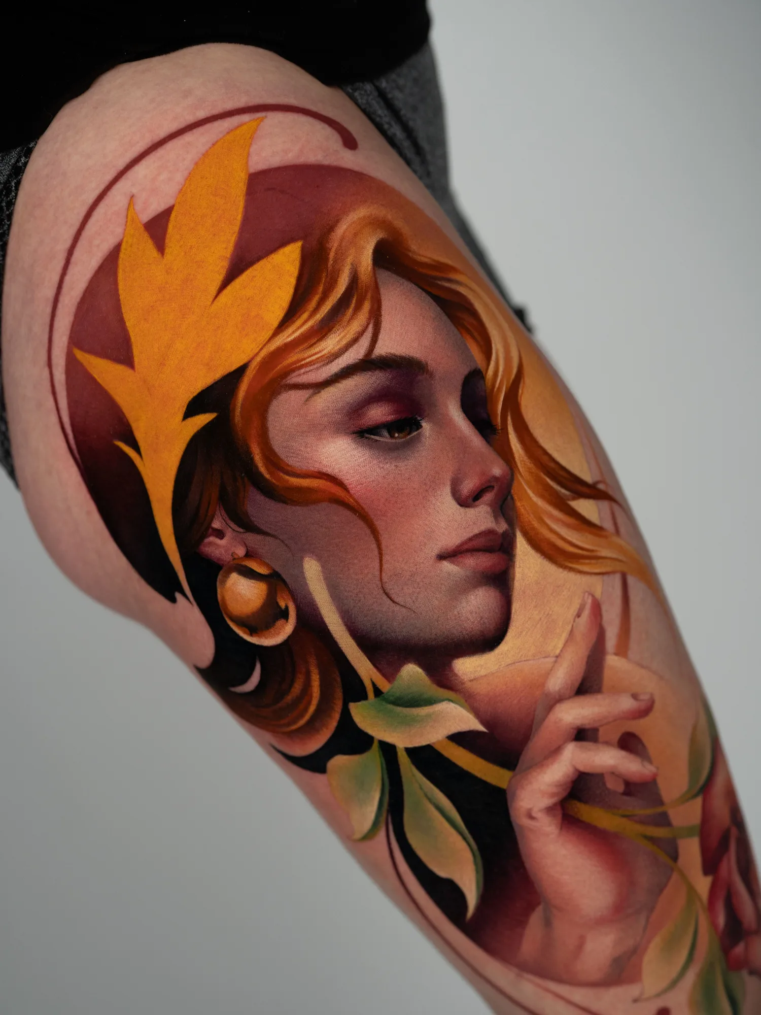 A detailed portrait of a woman with golden hair and leaves in a painterly style on the thigh.