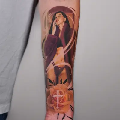 Realism tattoo of a woman and rose on forearm