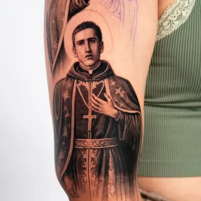Black and grey tattoo of a religious figure on upper arm