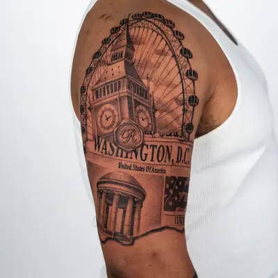 Tattoo of Big Ben and US landmarks on a man's arm.