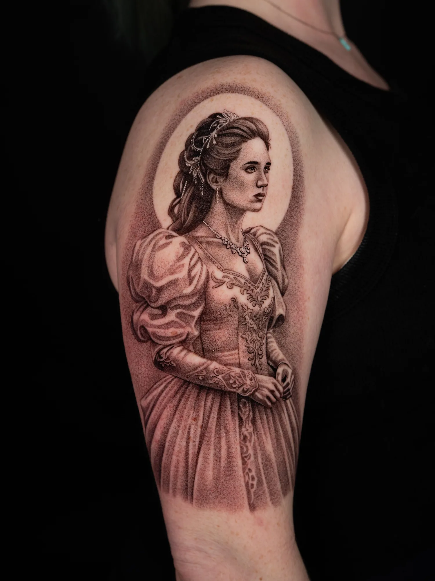 Detailed portrait tattoo of a woman in a historical ballgown, with intricate shading.