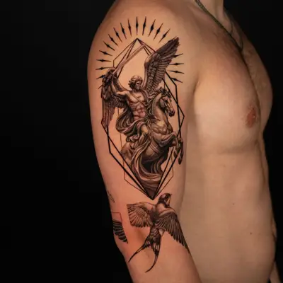 A detailed tattoo featuring a winged angel on a horse, with geometric elements and birds.
