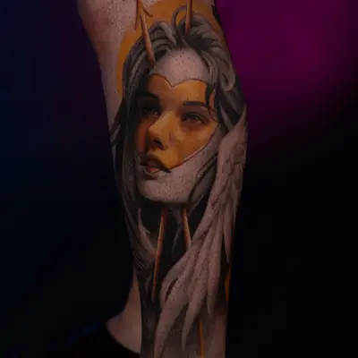 Tattoo of a woman with arrows and a halo on a calf done in a black and grey style with a gold heart on the face.