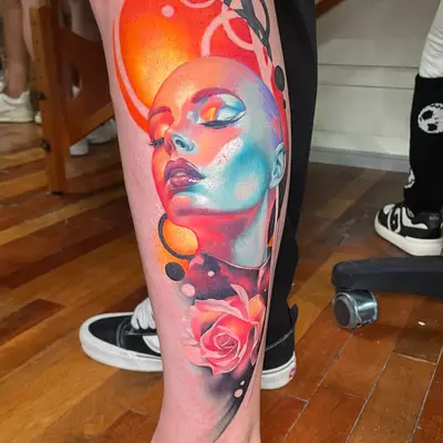 Colorful portrait tattoo on leg featuring a stylized female face and rose.