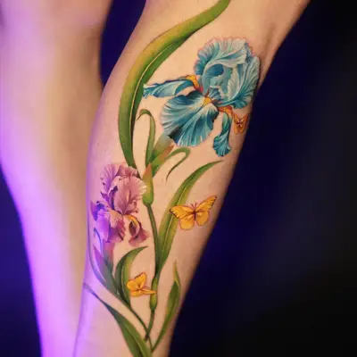 Colorful floral tattoo with butterflies on leg