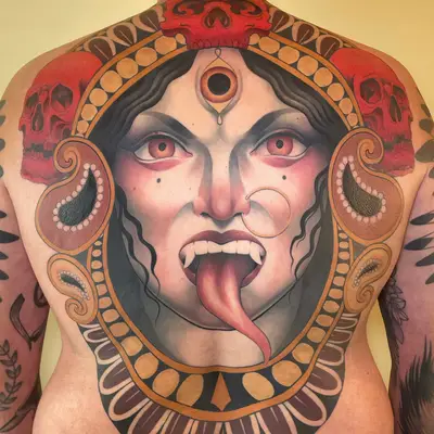 Large back tattoo featuring Kali with skulls and ornate design.