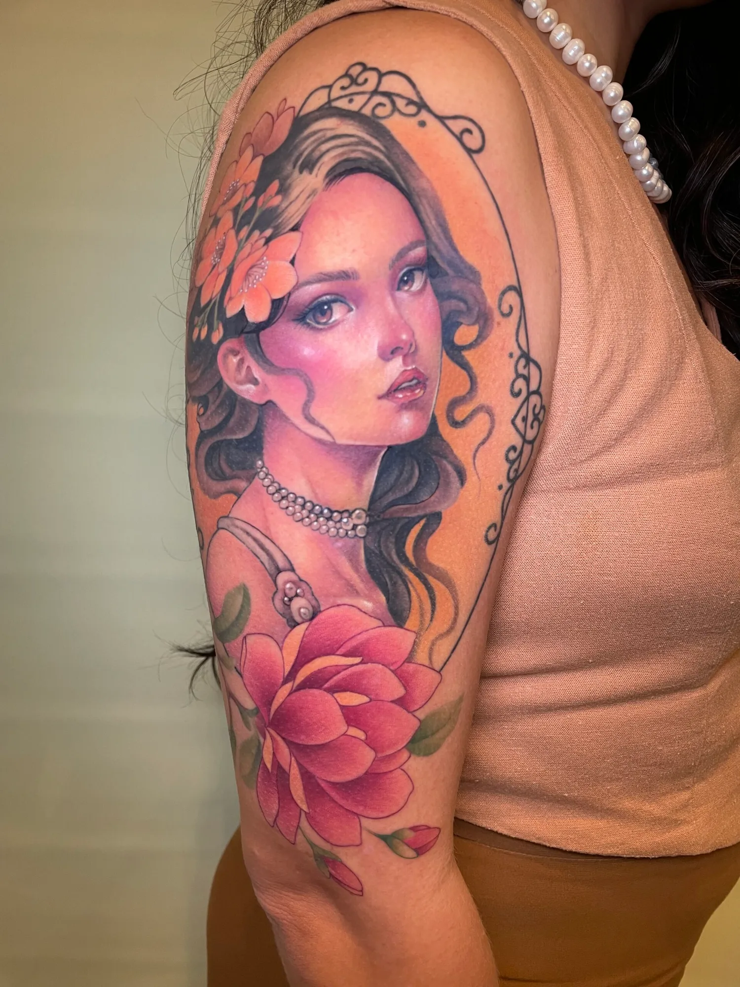 Tattoo of a woman with flowers on her arm.