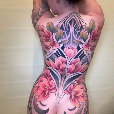 Floral and geometric back tattoo design on a person.