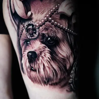 Realistic dog portrait tattoo with pearls and crown detail.