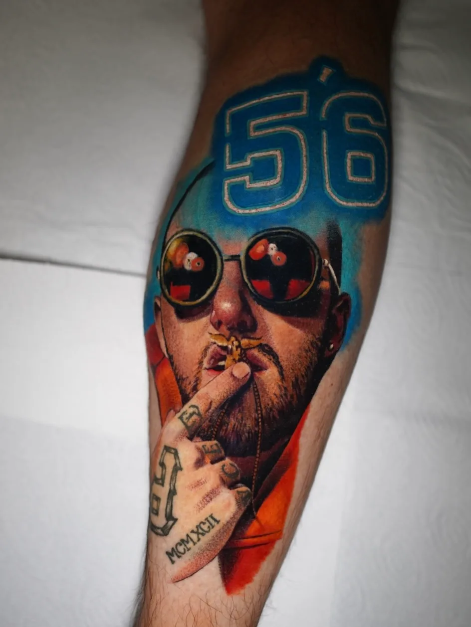 Tattoo of a man with sunglasses and number 56 on forearm.