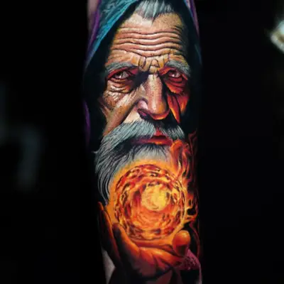 Colorful wizard tattoo holding a glowing orb