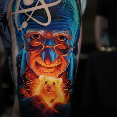 Tattoo of an elderly man holding a glowing mouse, with an atom symbol above his head.