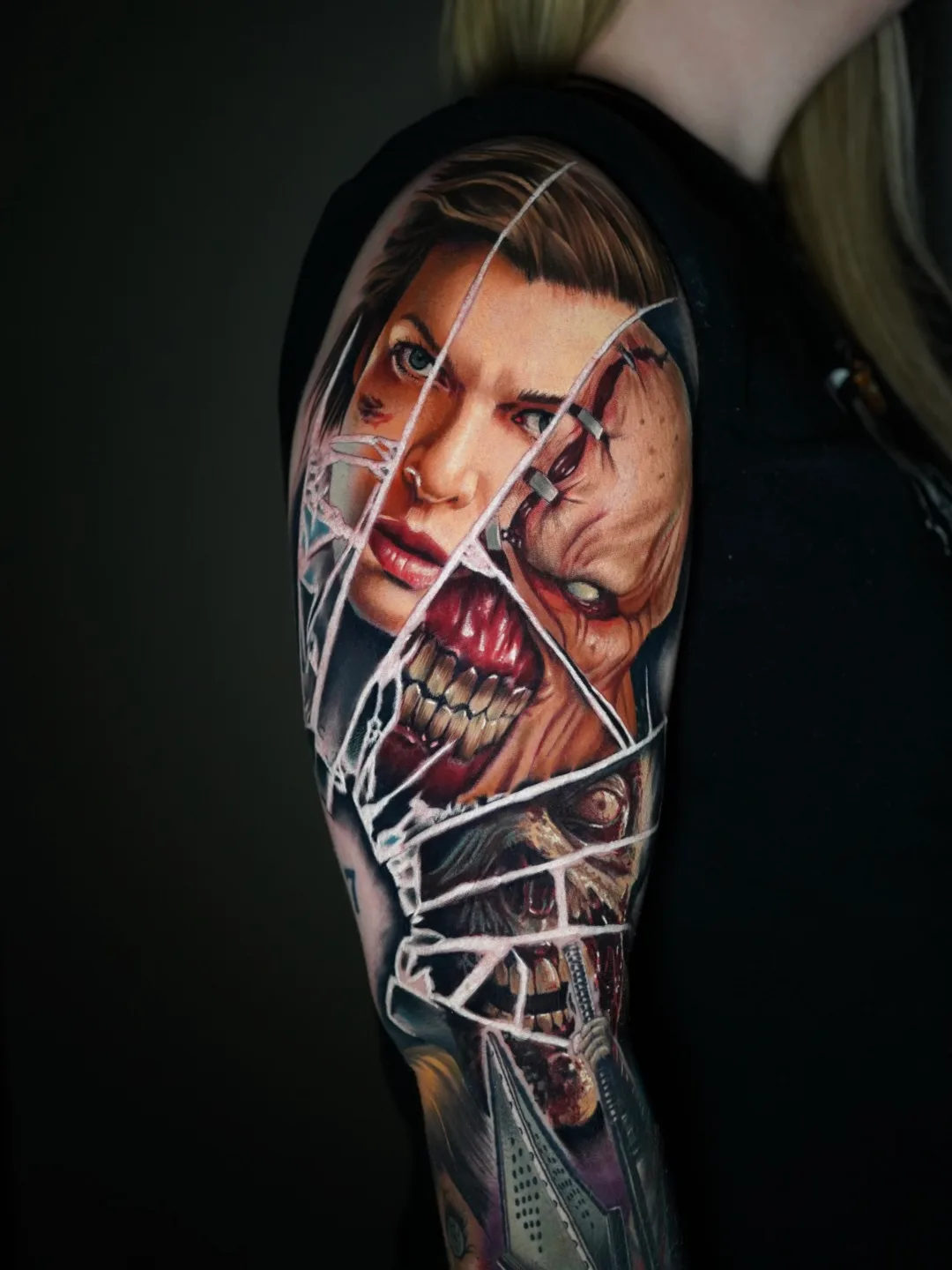 Realistic tattoo featuring a woman's face and a monstrous figure on an arm sleeve.