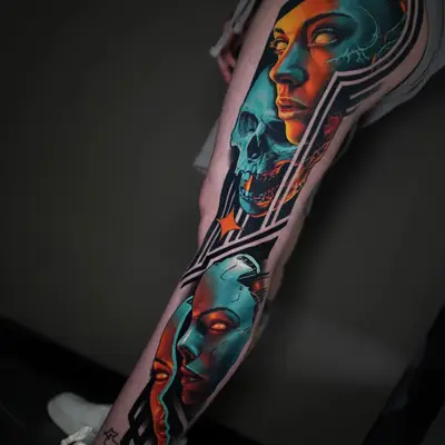 Abstract tattoo of faces and skull on leg