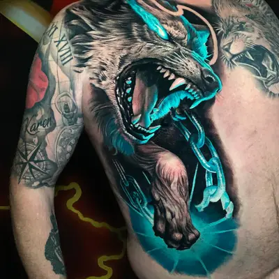 Tattoo of a fierce wolf with glowing blue accents on a person's chest.