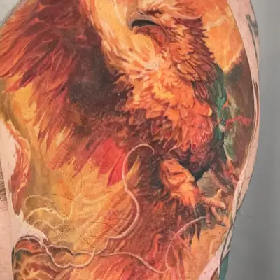 Vivid phoenix tattoo with flames on upper arm