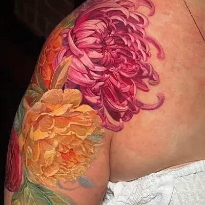 Colorful floral tattoo on shoulder.