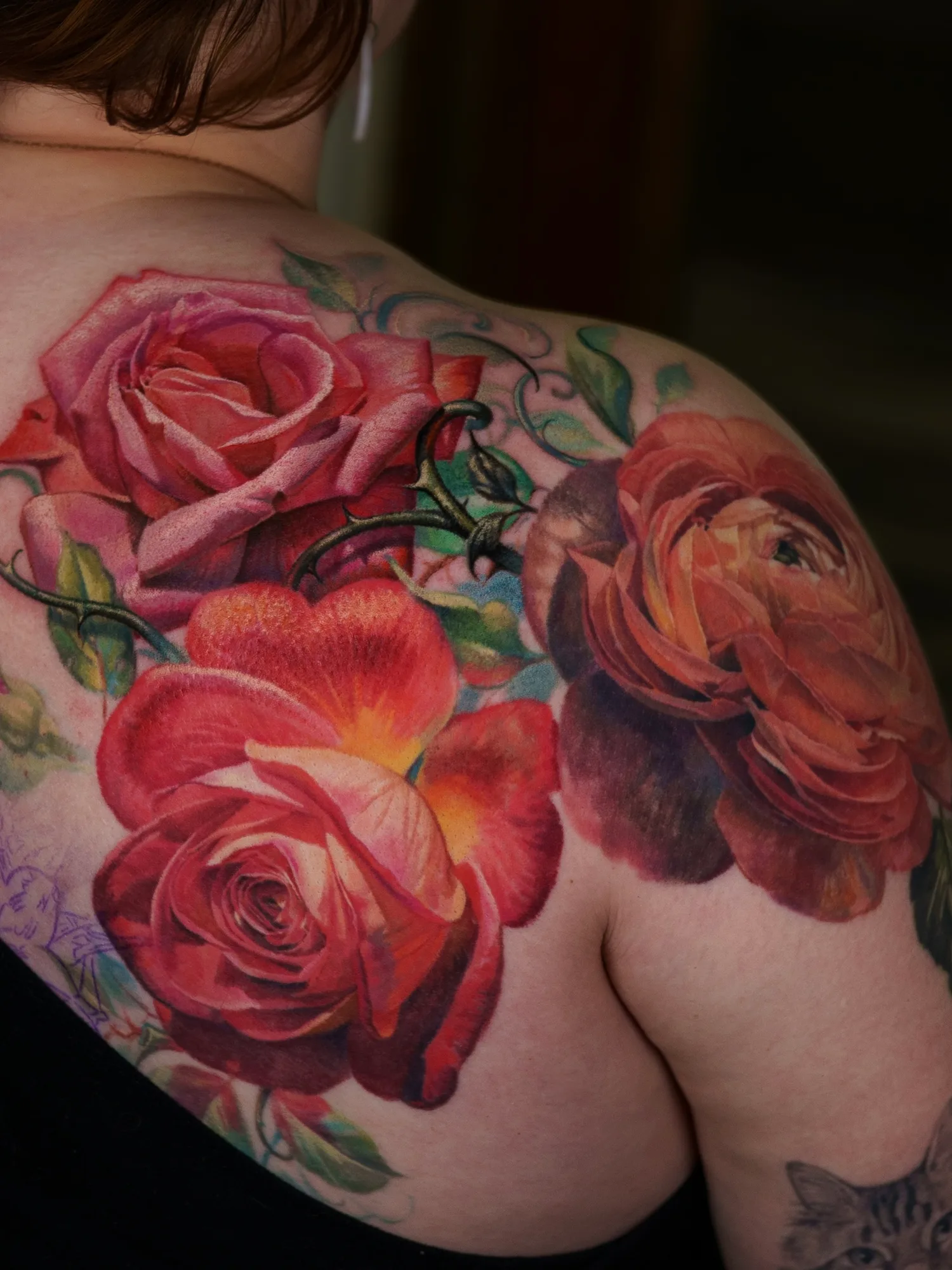 Realistic floral tattoo with roses on shoulder