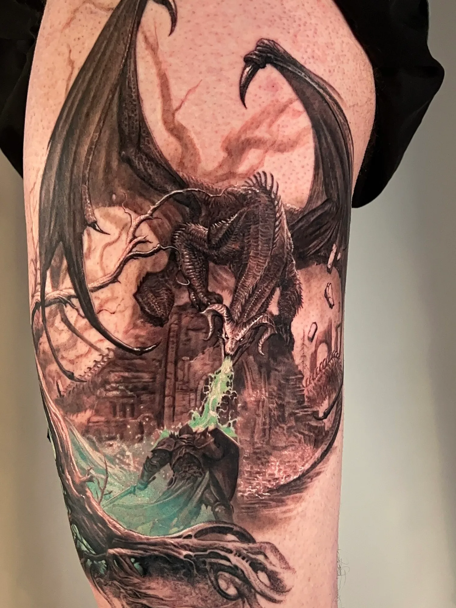Dragon breathing fire in detailed fantasy tattoo
