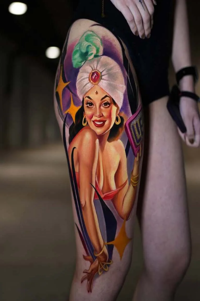 Colorful tattoo of a woman wearing a turban on a person's thigh.