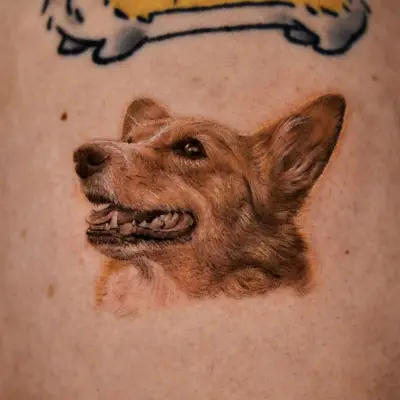 Realistic tattoo of a dog's head on skin.