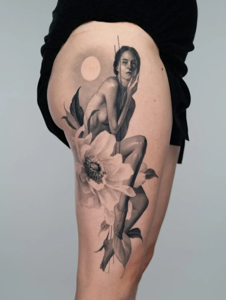 Tattoo of a woman sitting on a flower with a moon in the background.