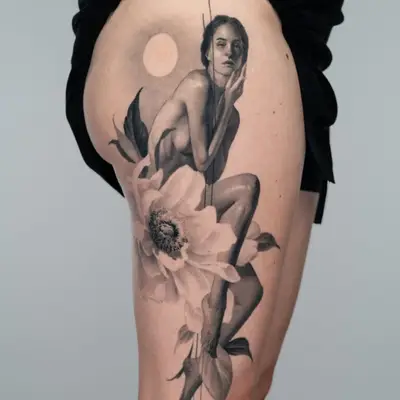Tattoo of a woman sitting on a flower with a moon in the background.